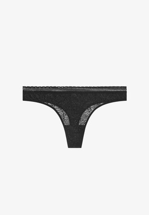 Zwarte kanten string met een bloemenpatroon, voorzien van een gegolfde rand en doorschijnende zijkanten, die de intrigerende ontwerpdetails en textuur accentueert.