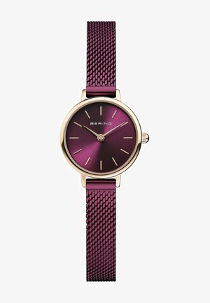 Bering-Uhr mit rundem goldenen Gehäuse, Zifferblatt mit tiefem lila Farbverlauf, goldenen Stundenmarkierungen und einem strukturierten lila Mesh-Armband.