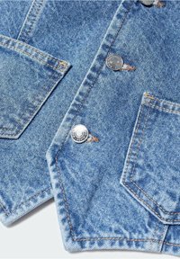 Denim vest, light blue with copper stitching. Features silver buttons and two chest pockets. Textured fabric with a classic design.