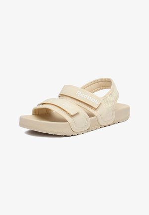 Beige Reebok-Sandale mit verstellbaren Klettverschlüssen mit zwei Riemen, strukturierter Sohle und Mesh-Fersenstütze.