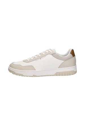 White and beige low-top sneaker with laces, thick sole, breathable mesh, and brown heel detail, branded with Tommy Hilfiger logo.