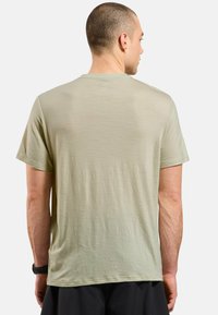 Light green short-sleeve t-shirt made of soft, lightweight fabric, featuring a round neck and a relaxed fit with minimal texture detail.