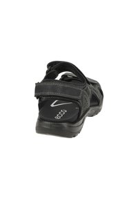 Black sport sandal with adjustable straps, textured synthetic upper, cushioned footbed, and patterned rubber sole for traction.