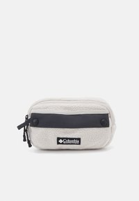 Columbia fleece pouch in light gray with a dark gray fabric strip, zip closure, and logo patch; textured surface. Compact design for convenience.