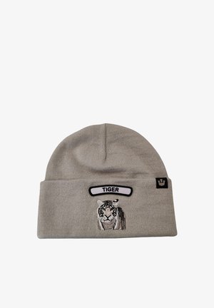 Berretto lavorato a maglia grigio con un design di tigre ricamato in bianco e nero e un'etichetta bianca con la scritta "TIGER" sopra.