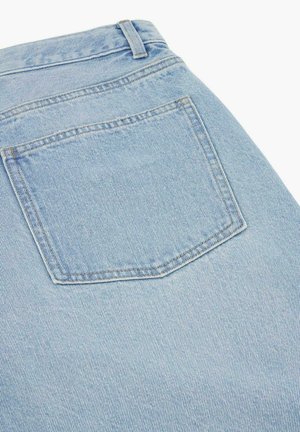 Jasnoniebieskie dżinsy z denimu pokazujące tylną kieszeń, szlufkę na pasek i szczegółowe przeszycia na teksturowanej tkaninie.