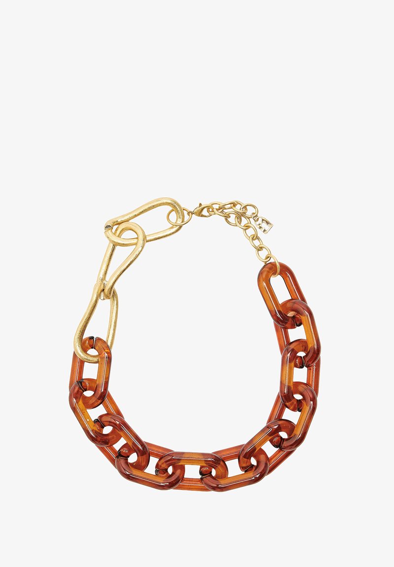 Gruba naszyjnik z dużymi linkami z żywicy o wyglądzie skorupy żółwia oraz przerośniętymi, teksturowanymi metalowymi ogniwami w kolorze złota, z zapięciem i łańcuszkiem przedłużającym w kolorze złota.