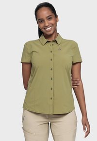 Short-sleeve olive green shirt with a collar, button-down front, side pockets, and a small logo accent on the chest. Smooth texture.