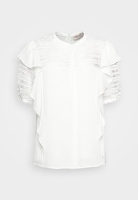 Blusa bianca con maniche corte a sbuffo, caratterizzata da dettagli simili a pizzo nella parte superiore e accenti arricciati lungo i lati.