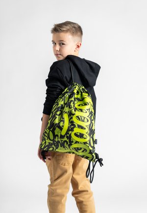 Drawstring bag in black and neon green with graphic text pattern; smooth, lightweight material; adjustable cord closure; compact design.