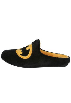 Zapatilla de felpa negra con un logo amarillo de Batman. Presenta una textura suave, diseño de abertura en la parte trasera y un forro interior blando.