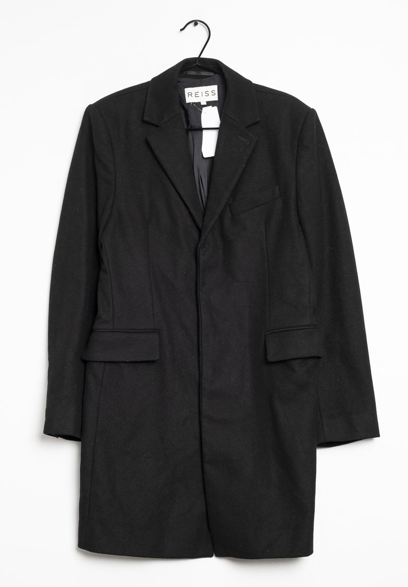 Blazer long noir en mélange de laine, avec un col cranté, des poches avant et une boucle de suspension. Texture lisse avec une coupe ajustée.