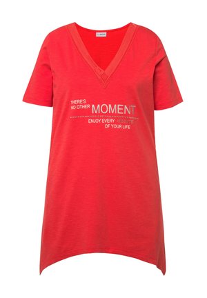 Rød V-hals t-shirt med korte ærmer, der har hvid tekst: "Der er ikke noget andet øjeblik. Nyd hvert minut af dit liv." Blondekant detaljer.