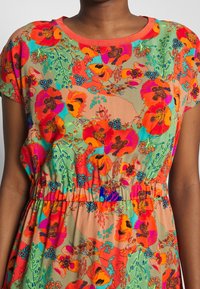 Blumenkleid mit lebhaften Mustern in Orange, Grün und Blau; kurze Ärmel; geraffter Taillengurt; weicher, leichter Stoff.