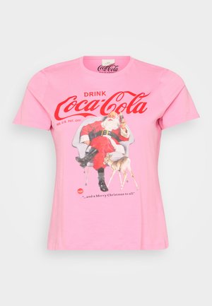 Pink cotton t-shirt featuring a vintage Coca-Cola graphic of Santa Claus and a deer, with red text and detailing. Short sleeves and round neck.