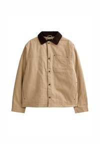 Beige skjortjacka med mörkbrun manchesterrandig krage, bröstficka fram och långa ärmar, utlagd plant på vit bakgrund.