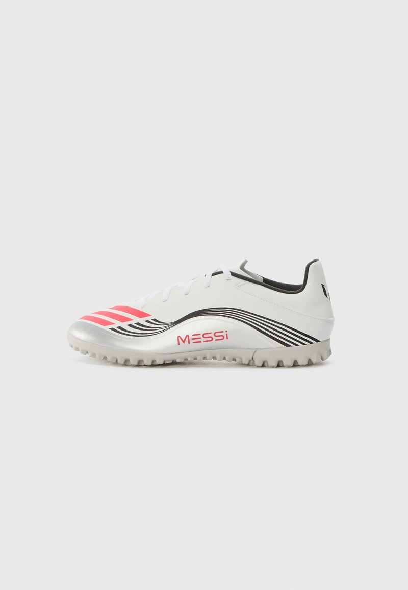 White soccer shoe with silver accents, pink stripes, and black wavy patterns. Features a textured sole for traction and 'MESSi' branding.