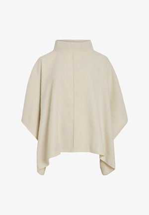 Cream-colored poncho made of soft textured fabric. Features a high collar and a loose, flowing design with asymmetrical hemline.