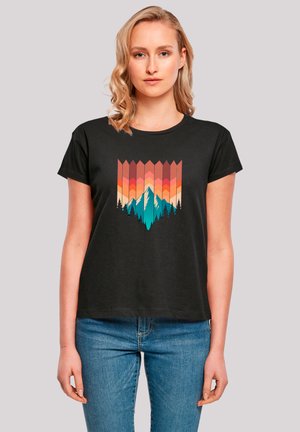 Black t-shirt with short sleeves features a colorful mountain and forest graphic in shades of orange, teal, and pink against the chest.