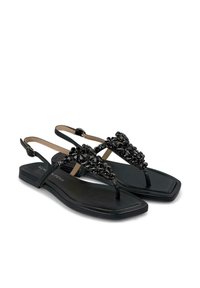 Zwarte platte sandalen met een teenstukontwerp, voorzien van een bloemenversiering met kralen op de bovenkant. De banden zijn verstelbaar met een gesp.