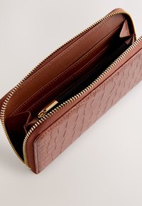 Brown textured wallet made of synthetic material. Features a gold zipper and multiple interior compartments, including a black zippered section.