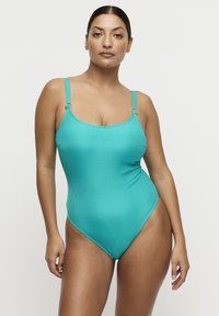 Maillot de bain une pièce turquoise côtelé avec fines bretelles et anneaux décoratifs aux épaules, doté d'une coupe haute au niveau des jambes.