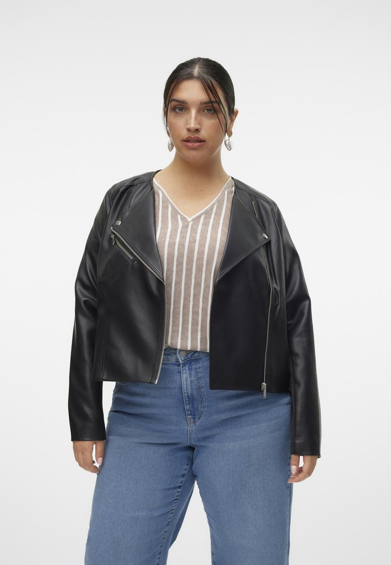 Jacket din piele ecologică neagră cu un design scurt, fermoar asimetric și mâneci lungi. Pur tată peste un top lătăc cu dungi de culoare deschisă, asortat cu blugi albaștri.