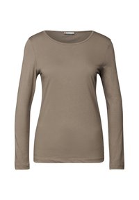 Pitkähihaisen paidan vaalea beige kangas, pyöreä pääntie ja sileä pinta, istuva malli ilman huomattavia yksityiskohtia.
