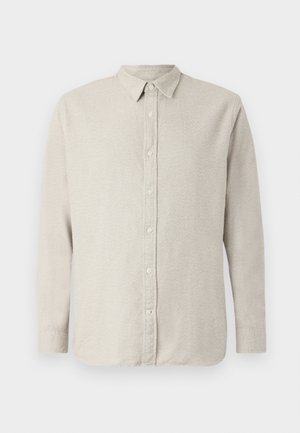 Beige langermet skjorte med krage som kan kneppes, med teksturert stoff og frontlukking med knapper. Nåværende stil med en avslappet passform.