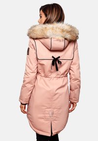 Pink parka with faux fur hood, drawstring waist, and black accents. Features logo patch and rear vent for mobility. Satin-like texture.