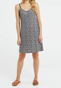 Vestido negro con estampado floral de tirantes finos, que presenta un patrón de pequeñas flores blancas y rojas. Tela suave, de longitud hasta la rodilla y corte relajado.