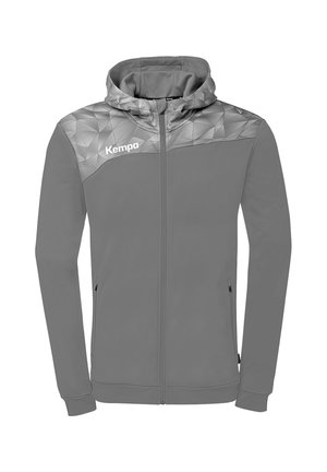 Sweat à capuche zippé intégral gris avec empiècement géométrique, poches latérales et logo "Kempa" sur la poitrine gauche.