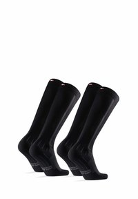 Schwarze kniehohe Socken aus einem glatten Material. Mit geripptem Design, gepolstertem Fersen- und Zehenbereich sowie dezentem Branding an der Oberseite.