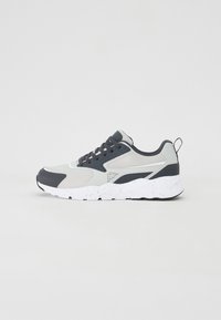Athletic sneaker with a grey and black mesh upper, contrasting rubber accents, and a white speckled sole. Features round laces and a pull tab.