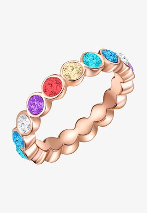 Vaaleanpunakultainen rengas, jossa on aaltoileva muotoilu ja jota koristavat moniväriset pyöreät kristallit: punainen, violetti, keltainen, sininen ja kirkas.