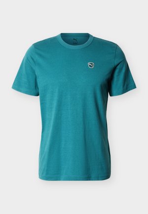 T-shirt di cotone color teal con maniche corte, scollo rotondo e piccolo logo ricamato sul petto. Tessuto liscio, leggero.