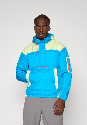 Lightweight, blue windbreaker jacket with yellow accents, elastic cuffs, adjustable hood, front pocket, and logo detail on chest.