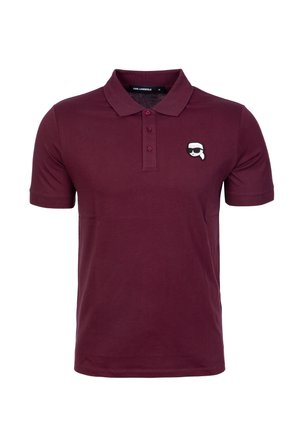 Polo de color burdeos con cuello, tapeta de tres botones y un pequeño logo gráfico en el lado izquierdo del pecho. Fabricado en tela de algodón, con una textura suave.