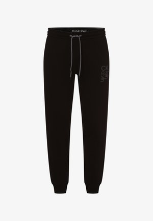 Černé tepláky Calvin Klein s tkaničkou v pase a olemovanými nohavicemi, s jemným vertikálním logem na pravém stehně.
