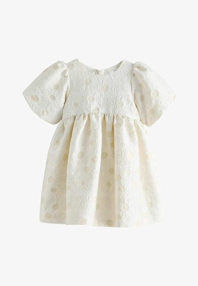 Kreemikas beebikleit pufvarrukatega ja tekstuurse lillemustriga, mille keskel on ümmargused detailid.