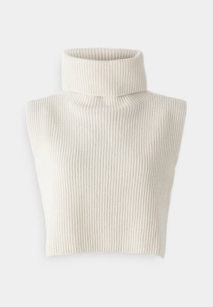 Pull en col roulé sans manches de couleur beige clair avec une texture côtelée. Il dispose d'un col haut et d'un design cropped.