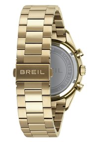 Guld rustfrit stål ur med et sammenkoblet armbåndsdesign, der har en sølvfarvet urskive og indgraveret mærkenavn på låsen.