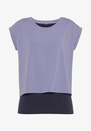 Short-sleeve top in light purple fabric with a round neckline, layered over a black base. Smooth texture with a relaxed fit and subtle stitching.