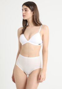 White triangular bra with thin straps and sheer high-waisted briefs. Smooth texture and simple design without additional patterns or accents.