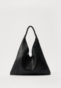 Black leather bag with a unique V-shaped opening, featuring a braided handle and a textured surface. Minimalist design with soft curves.