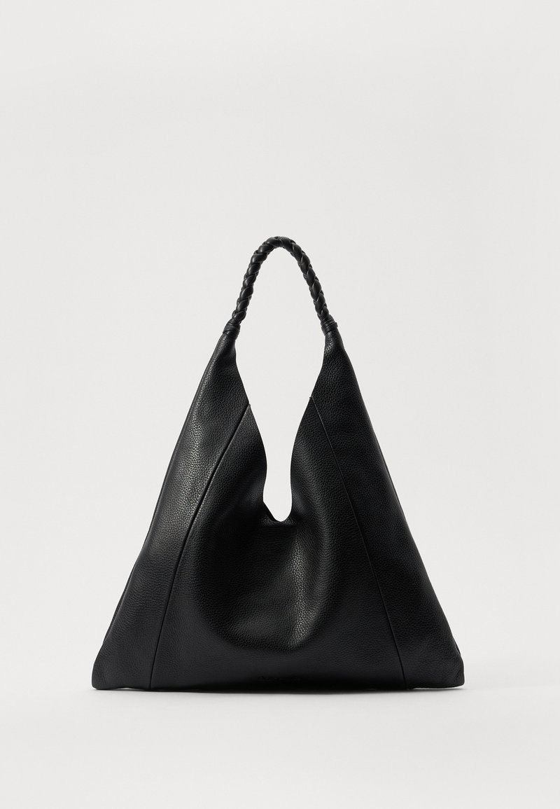 Black leather bag with a unique V-shaped opening, featuring a braided handle and a textured surface. Minimalist design with soft curves.