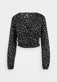 Black wrap top featuring a v-neckline, long sleeves, gathered hem, and a white speckled pattern on a textured fabric.