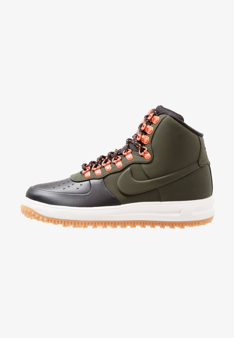 High-top sneakers in black and olive green, featuring orange eyelets, textured leather, and a white rubber sole with a gum outsole.
