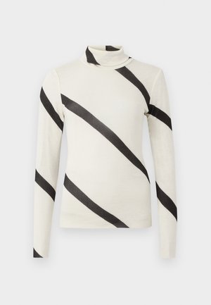 Langermet polo-genser i kremfarge med tydelige svarte diagonale striper, laget av et lett og glatt stoff. Slim-fit design, ingen synlige lukninger.