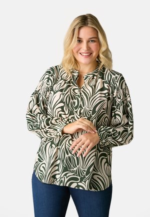 Blouse à manches longues en vert et crème avec un motif floral tourbillonnant, dotée d'un petit col et de poignets froncés, fabriquée en tissu léger.